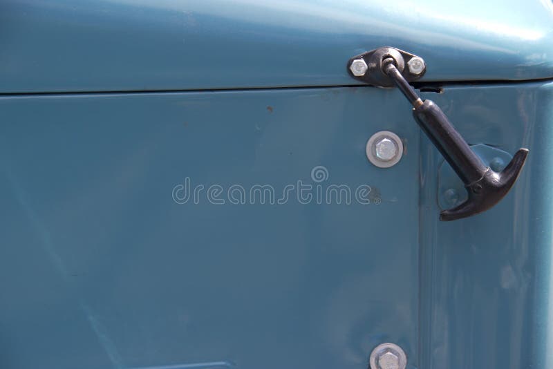 Old truck hood with latch in daylight stock photos Old truck hood with latch in daylight stock photos