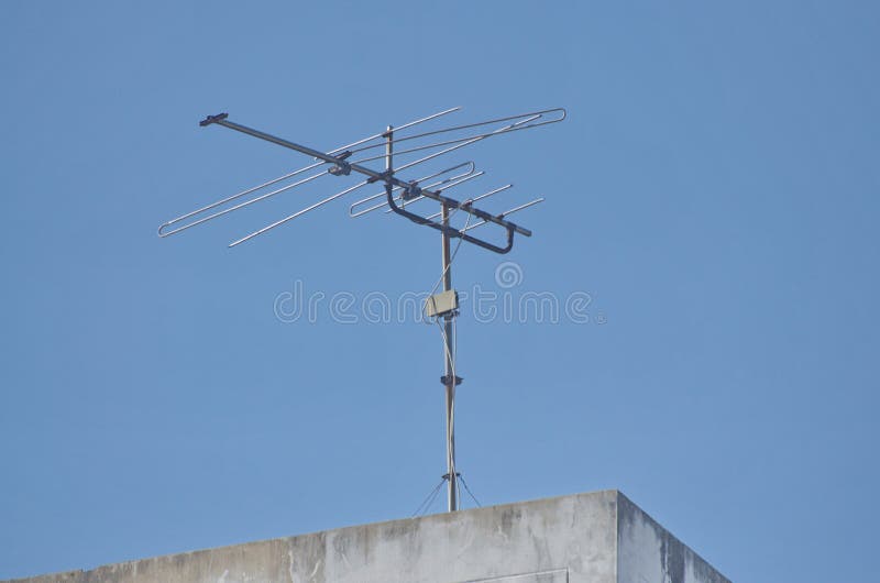 Old TV Antenna Installed on the Roof of the Building Stock Photo