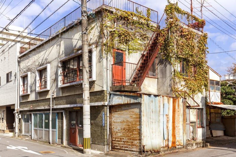 An old two-storey house covered with wild grapes in the Japanese city of Beppu on the island of Kyushu. An old two-storey house covered with wild grapes in the Japanese city of Beppu on the island of Kyushu