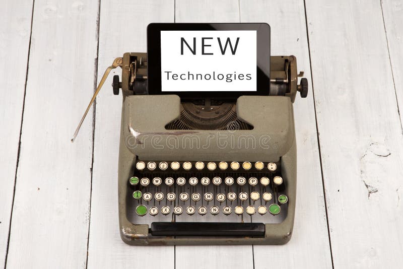 old typewriter and new tablet pc with words & x22;NEW Technologies& x22