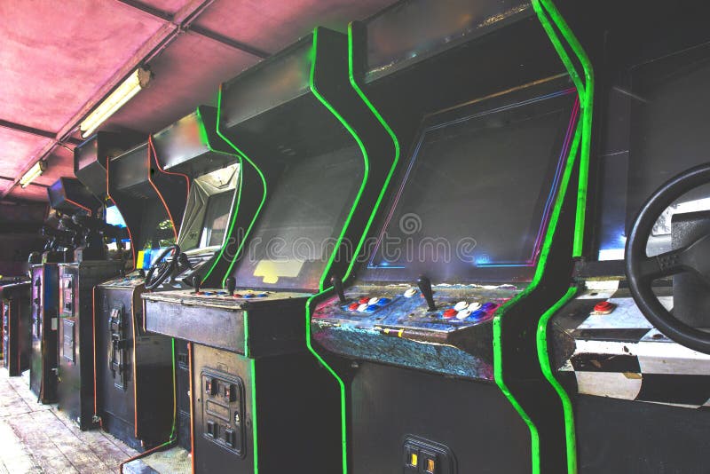 Old used classic forgotten Vintage Arcade in room and none of players playing video games in the frame. Game machine cabinet with royalty free stock images Old used classic forgotten Vintage Arcade in room and none of players playing video games in the frame. Game machine cabinet with royalty free stock images