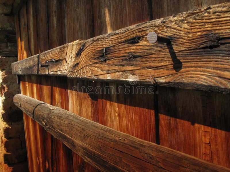 Old Vertical Wood Plank Wall with Two Horizontal Planks with Nails in