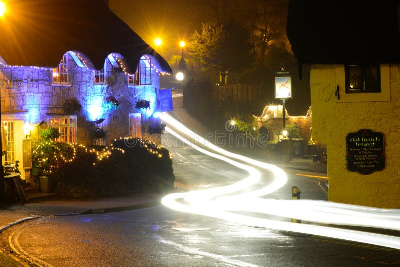 The Village Inn is a traditional English pub situated in the Old Village at Shanklin on the Isle of Wight. Here it can be seen decorated for the Christmas holiday season with the Crab Inn in the background. Car headlights streak passed during a long exposure photograph creating a mystical and enchanting festive scene. The Village Inn is a traditional English pub situated in the Old Village at Shanklin on the Isle of Wight. Here it can be seen decorated for the Christmas holiday season with the Crab Inn in the background. Car headlights streak passed during a long exposure photograph creating a mystical and enchanting festive scene.