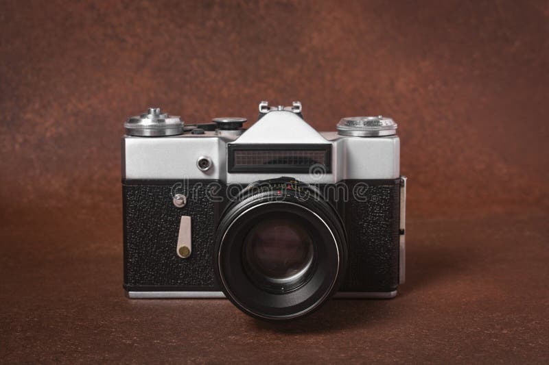 Old vintage film camera on brown background close-up. Vintage film camera on a brown background. Old vintage film cameras stock images, royalty-free photos and pictures