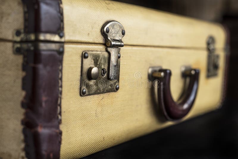 Old vintage hard yeallow suitcase with latch lock and handle tor