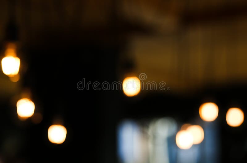 Vintage luxury interior lighting blurred background. Light bulbs blurred in the dark space. Vintage luxury interior lighting blurred background. Light bulbs blurred in the dark space.