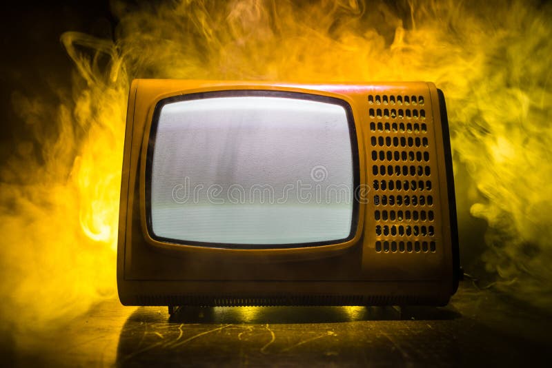 Old vintage red TV with white noise on dark toned foggy background. Retro old Television reciever no signal