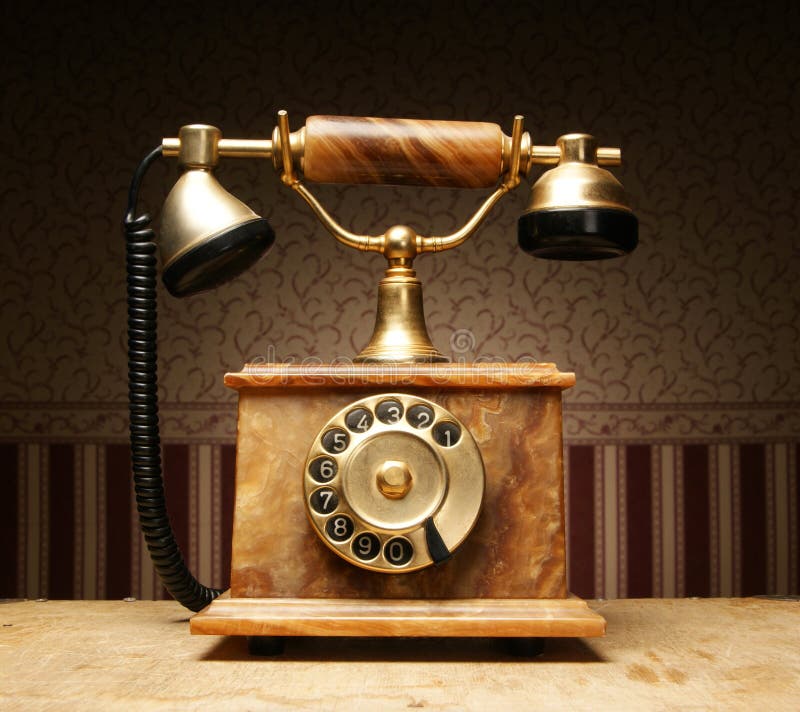 An old vintage telephone standing on a table