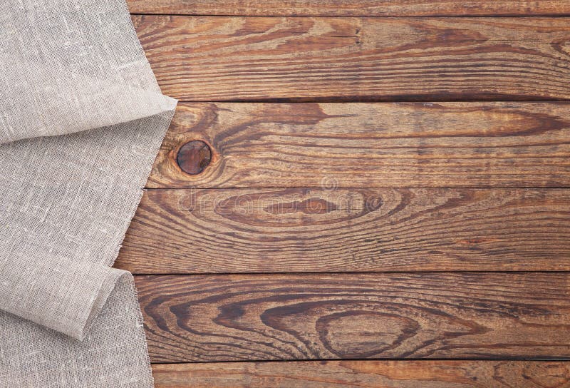 Old vintage wooden table with a red checkered tablecloth. Top view mockup.