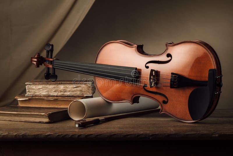 Old violin still life with books