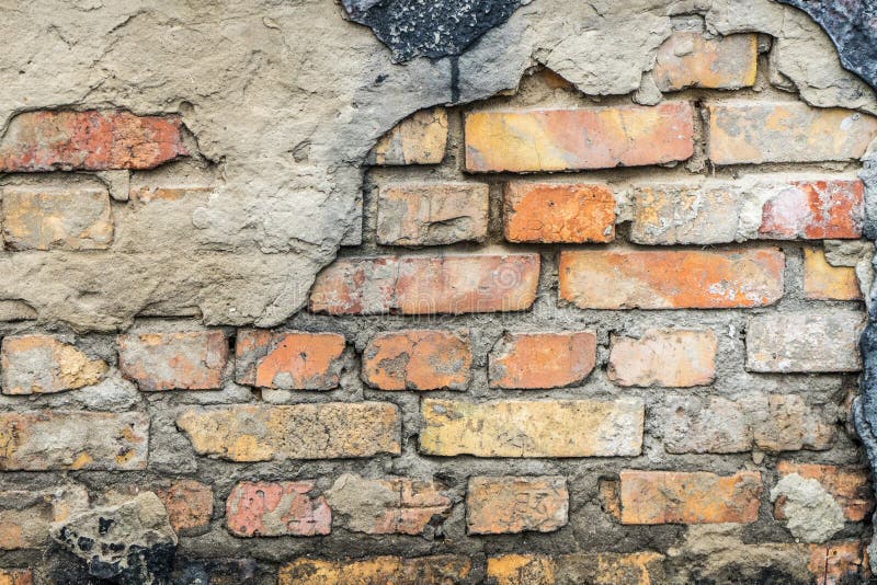 The Old Wall of the House. Under Loose Plaster Exposed Brick Wall