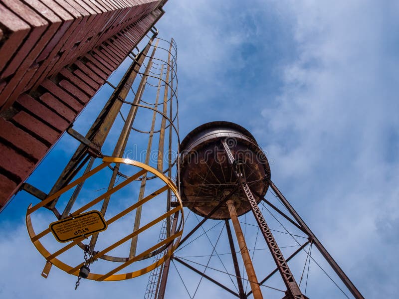 Water tower and safety ladder at Camp North End in Charlotte, North America, USA with blue sky and clouds