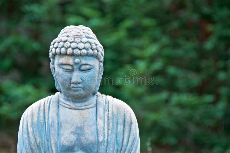 Old weathered garden buddha statue