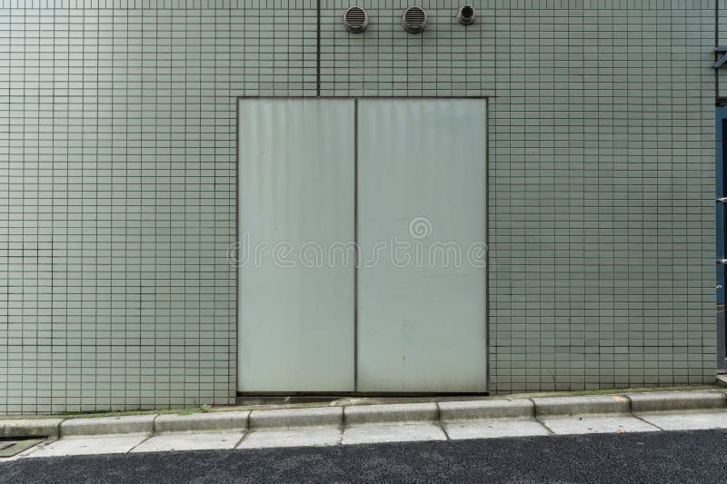 Roll Up Garage Door on Brick Wall Stock Image Image of block, gray