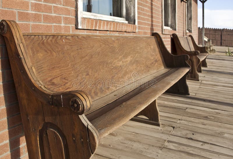 Old Western church pews outside bank