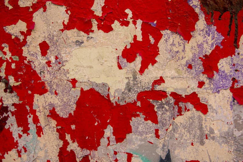Old white gray battered concrete wall with peeling bright red paint. rough surface texture stock photography Old white gray battered concrete wall with peeling bright red paint. rough surface texture stock photography
