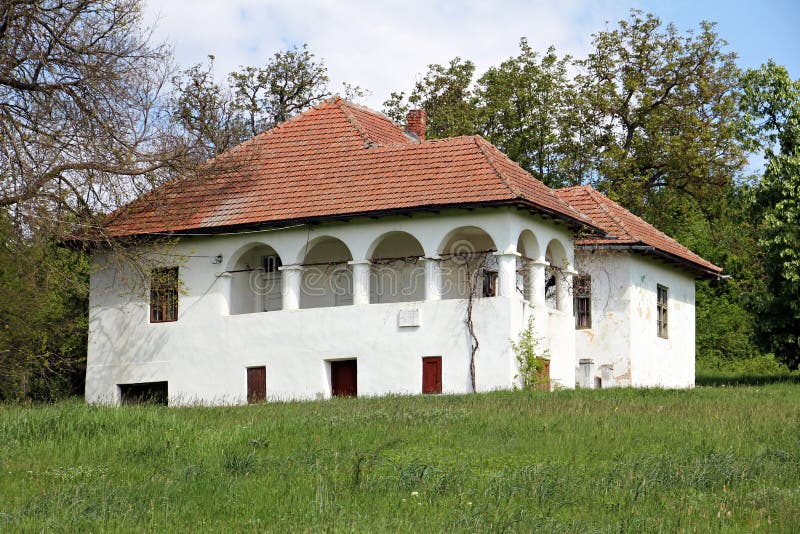 Old white mansion in rural landscape