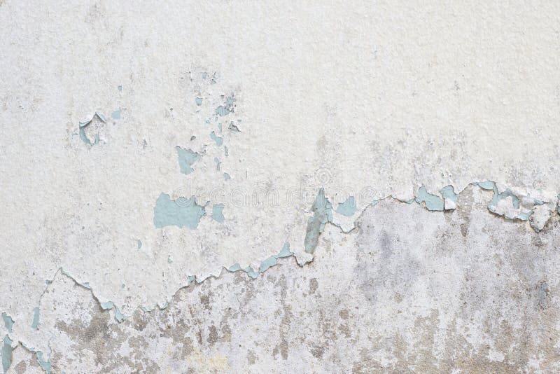Old white paint texture peeling off concrete wall