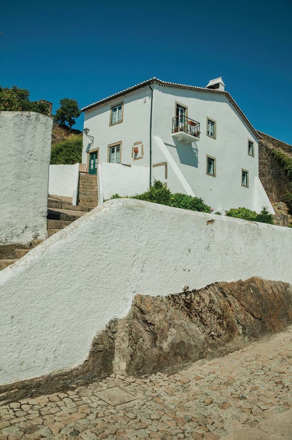 Old whitewashed wall house over rocks with stairs and plants royalty free stock images Old whitewashed wall house over rocks with stairs and plants royalty free stock images