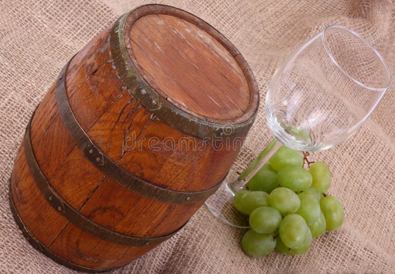 Old barrel with glass and green grapes. Old barrel with glass and green grapes