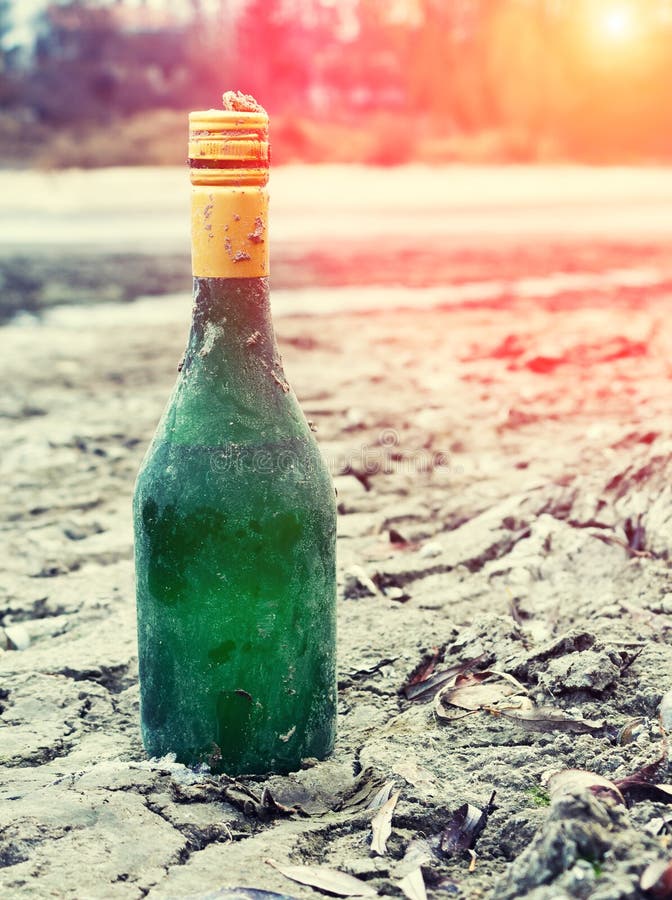 Old Wine Bottle Green Lies on the Waterfront in the Sand Stock Image