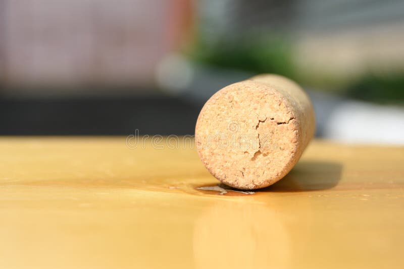 Old wine cork on the light brown table.