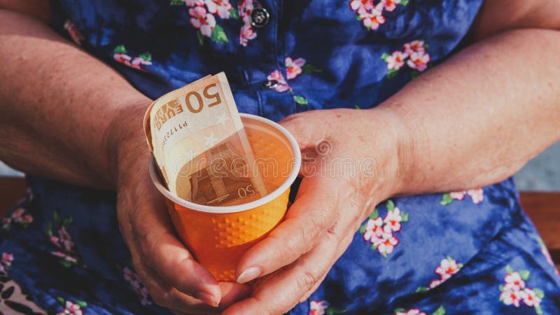 Old woman begs for alms. Closeup of money and coins in hand of poor woman royalty free stock photos Old woman begs for alms. Closeup of money and coins in hand of poor woman royalty free stock photos