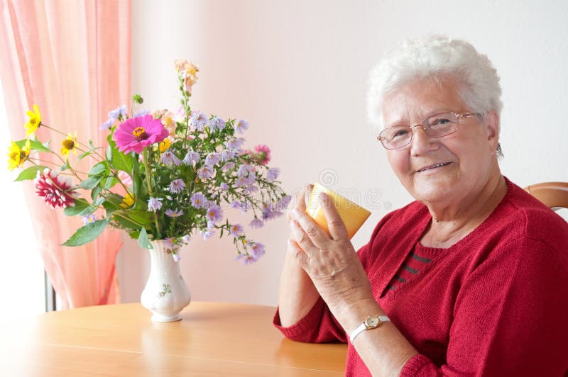 Old woman with cup stock photo Old woman with cup stock photo