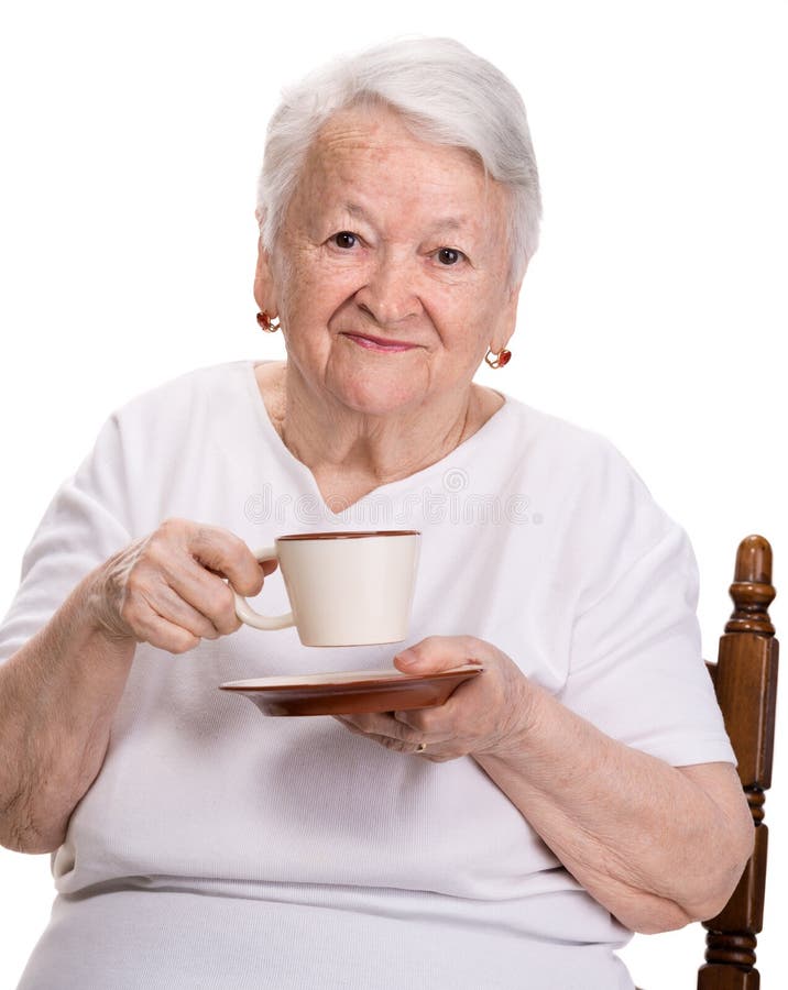 Old woman enjoying coffee or tea cup