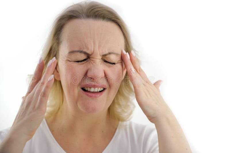 Attractive woman having a headache on white background Old woman with a headache holds her hands to her temples royalty free stock photo