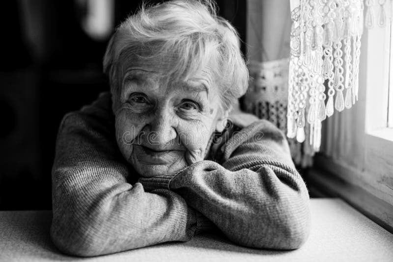 An old woman looking at the camera. Black and white photography