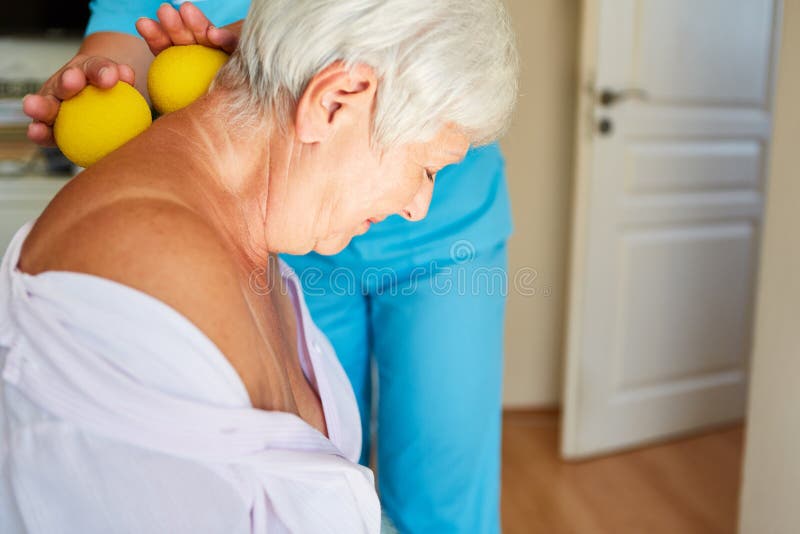 Old woman in rehab gets a neck massage in physiotherapy with small balls. Old woman in rehab gets a neck massage in physiotherapy with small balls