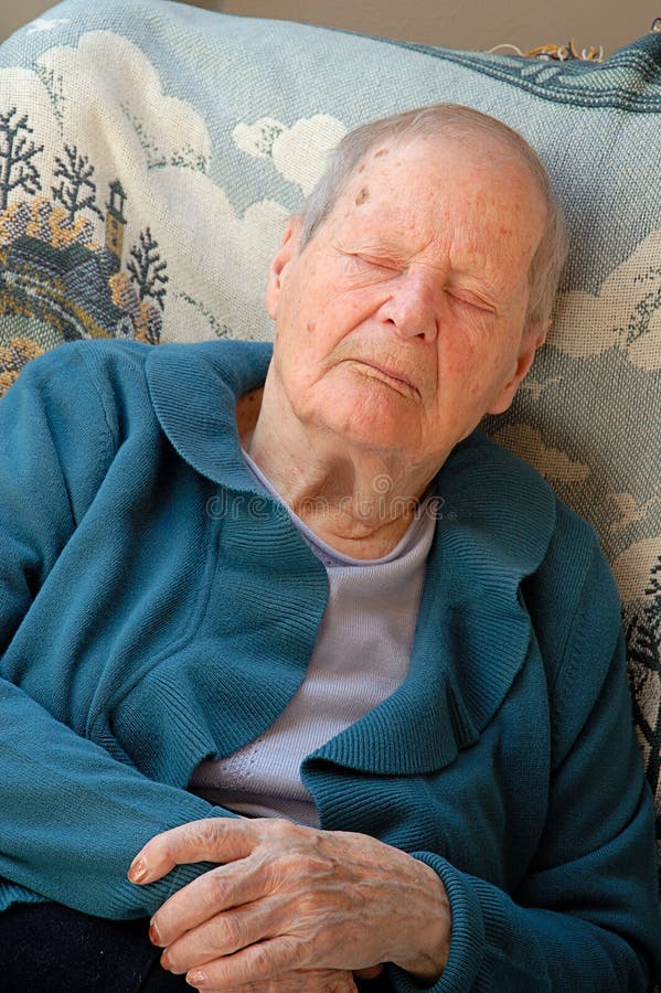 Senior womat has a catnap in the arm chair. Regenerate stock images, royalty-free photos and pictures
