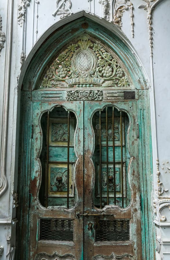 old wood door with stucco cement wall