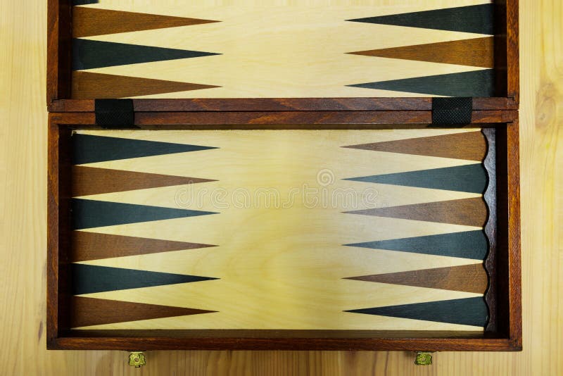 An old wooden backgammon Board on a wooden table stock images An old wooden backgammon Board on a wooden table stock images