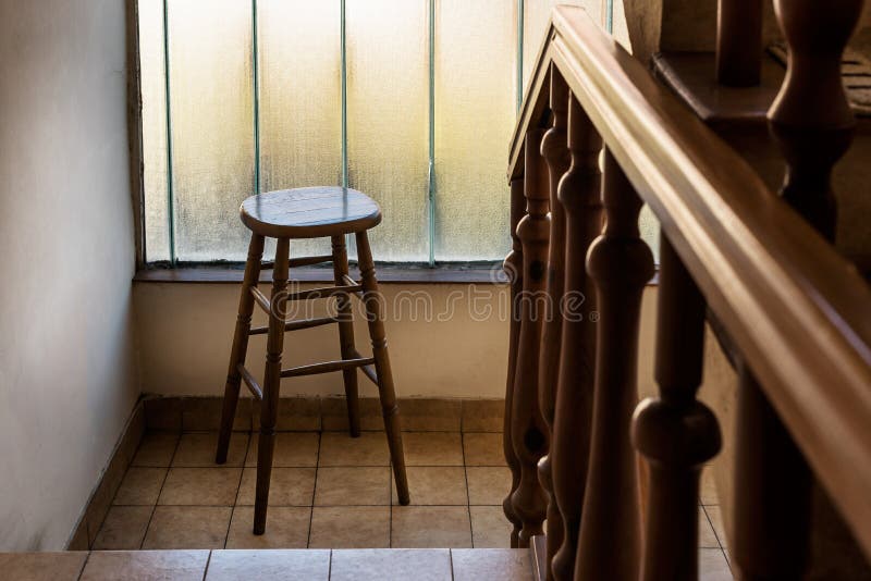 Old wooden Bar Stool in a Wooden Staircase with Handrailing in an Old house