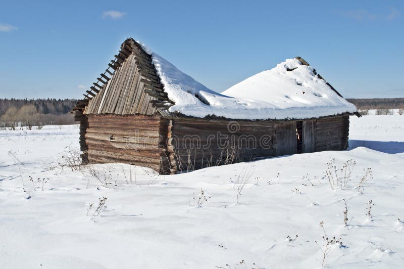 Old wooden barn under snow