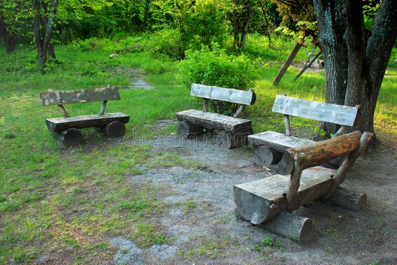 Old Wooden Benches Hand Made from Tree Trunks in the Forest Stock Image