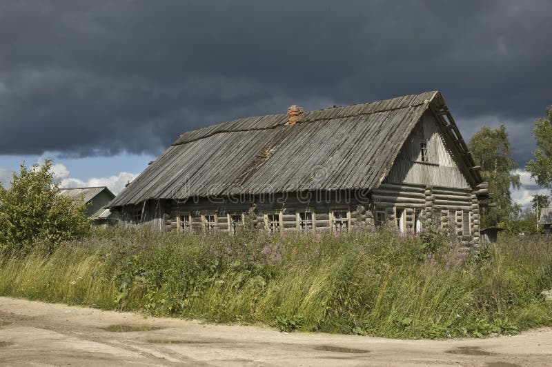 Old wooden country house before storm