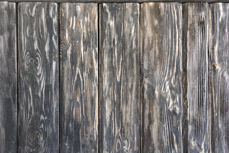 Old wooden dark background consisting of shabby black-brown textured boards. stock photos Old wooden dark background consisting of shabby black-brown textured boards. stock photos