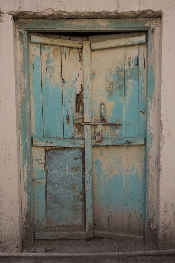 Old wooden door With blue cracked paint