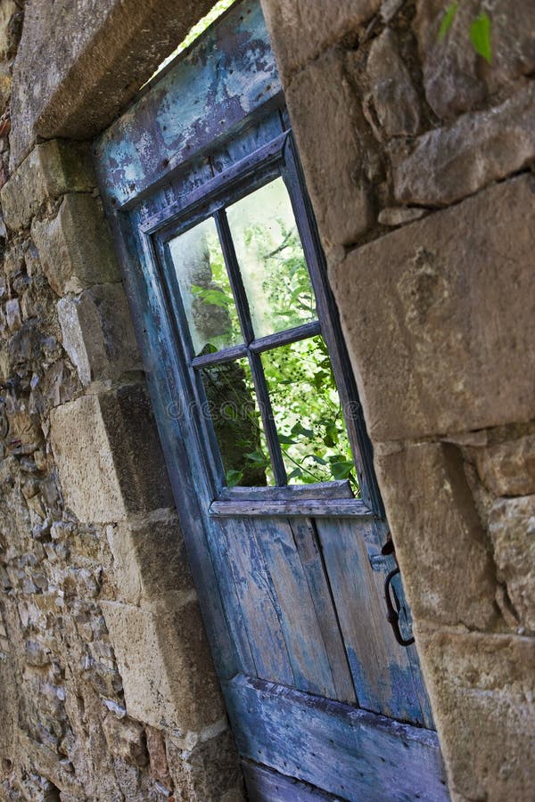 Old blue wooden door of a house in ruins. Old blue wooden door of a house in ruins