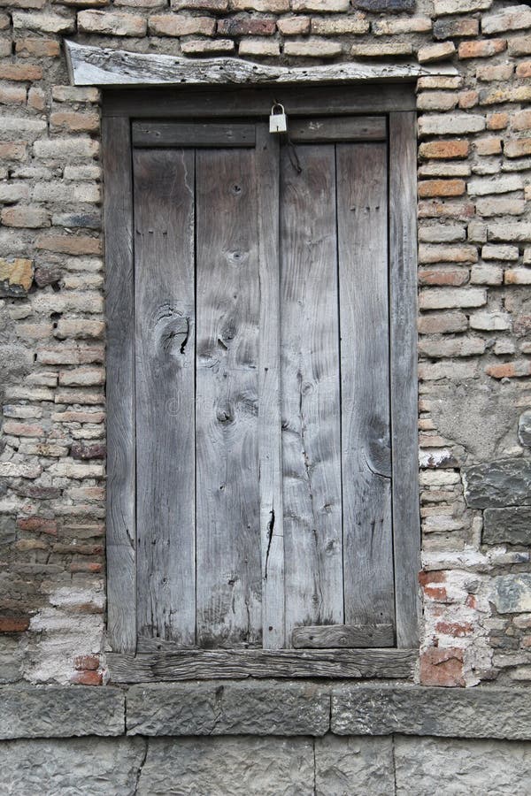 Vintage door with lock in ruins of brick stoned wall. Vintage door with lock in ruins of brick stoned wall