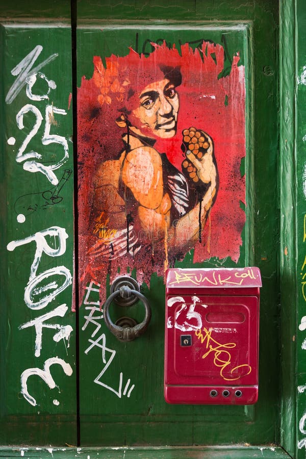 Old wooden door covered with graffiti in Trastevere district. Rome, royalty free stock photography Old wooden door covered with graffiti in Trastevere district. Rome, royalty free stock photography