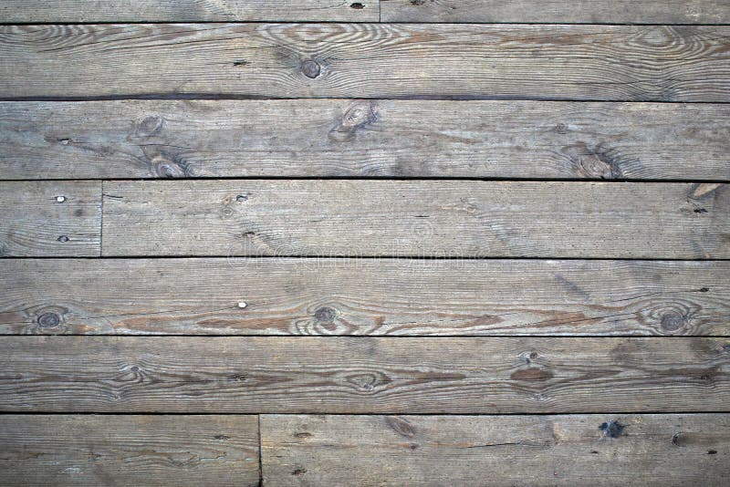 Old wooden gray flooring with knots and cracks