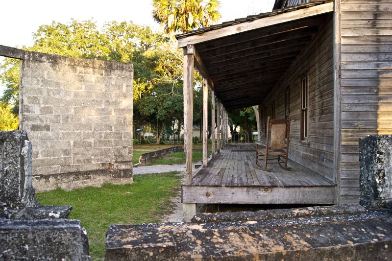 Old wooden home and broken wall