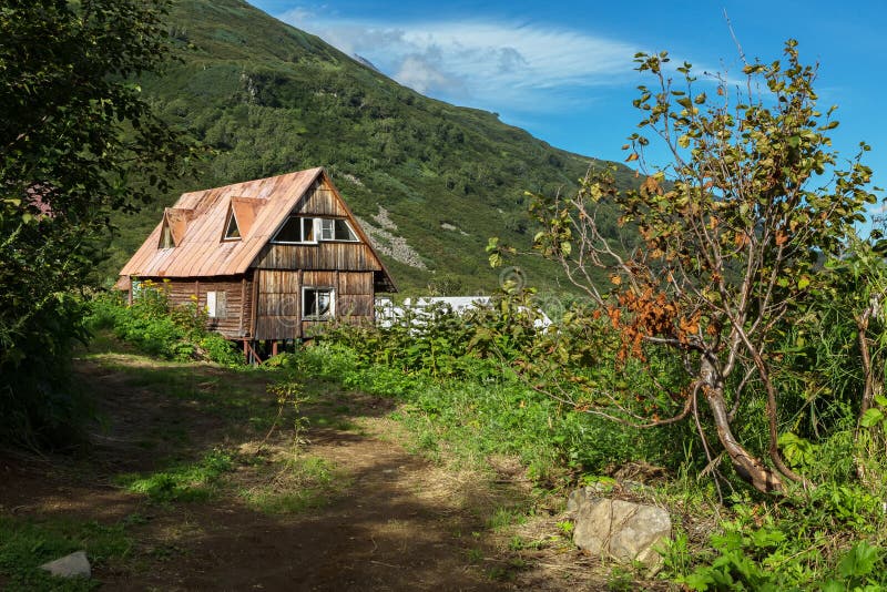 Old wooden house in brookvalley Spokoyny at the foot of outer north-eastern slope of caldera volcano Gorely.