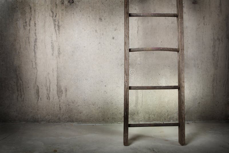 Old wooden ladder on a cement wall