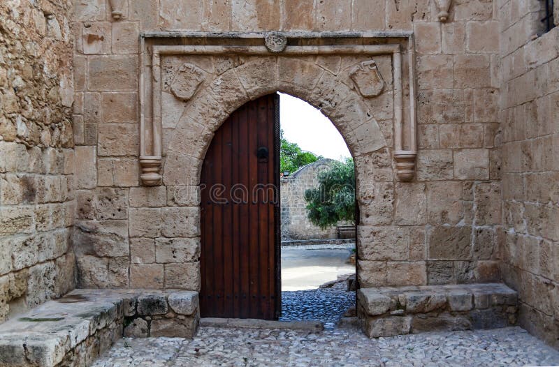 Old wooden open door on a stone wall: a way out of the castle stock photos Old wooden open door on a stone wall: a way out of the castle stock photos