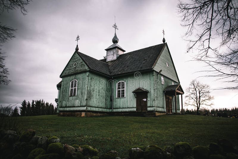 Kalnalis, Lithuania - november 25 2020: An old wooden church stands on the hill.